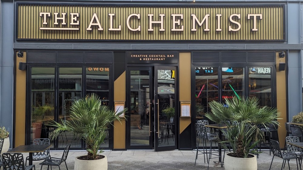 The Alchemist bar and restaurant frontage, with outdoor seating on the terrace.