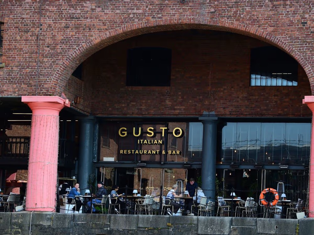 Gusto Italian Restaurant and Bar beneath the brick dock arches at the Royal Albert Dock, Liverpool, with waterside terrace seating. Photo: Colin Lane.